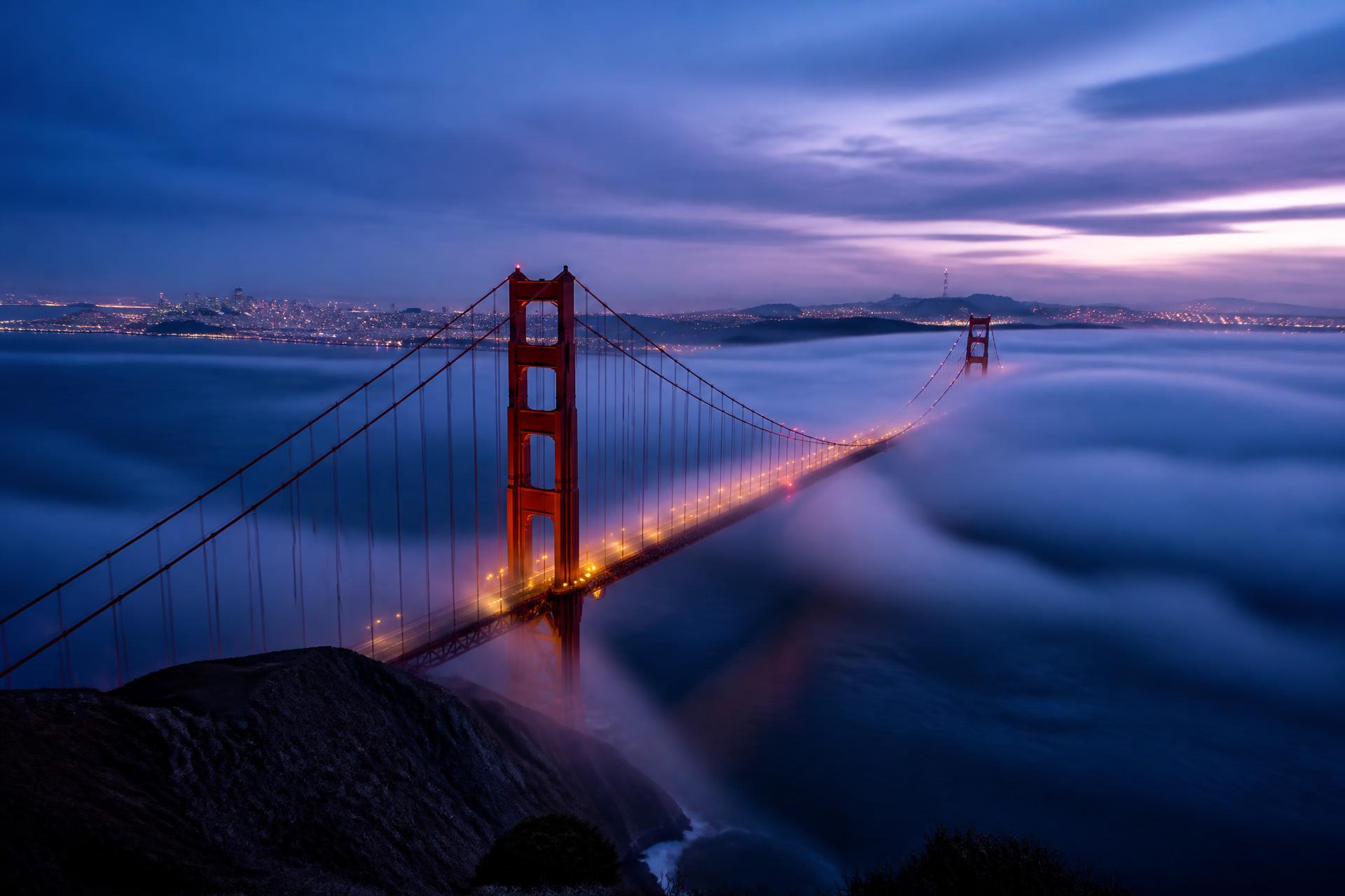 The Golden Gate Bridge in San Francisco fog at blue hour